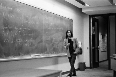 me, standing in front of blackboard